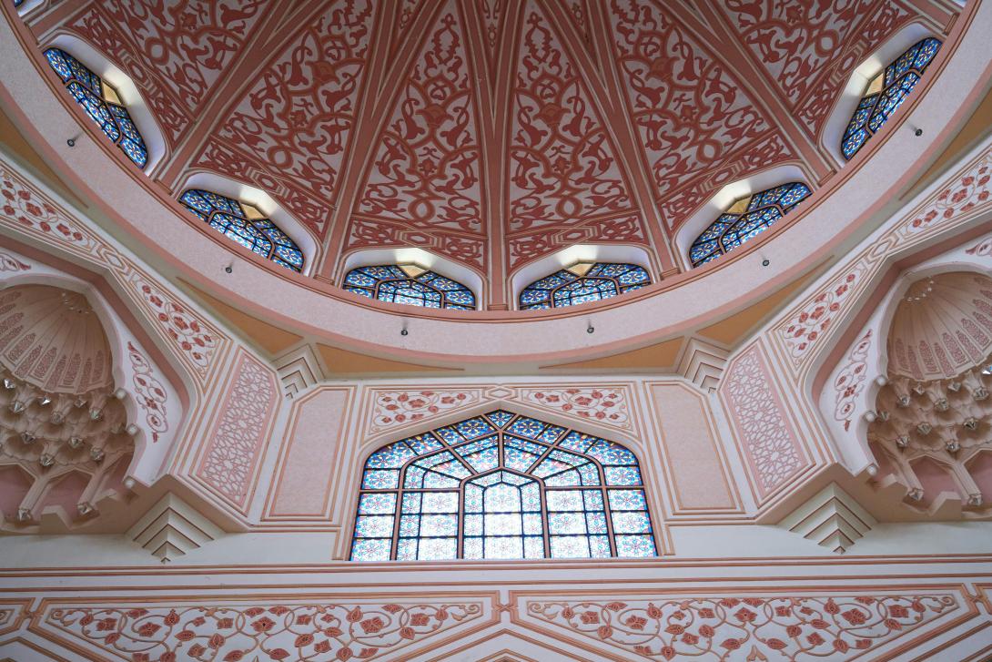 View of a red and blue Isalmic temple with intricate floral and geometric patterns