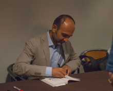 Mohsin Hamid signing one of his books - Lehigh University